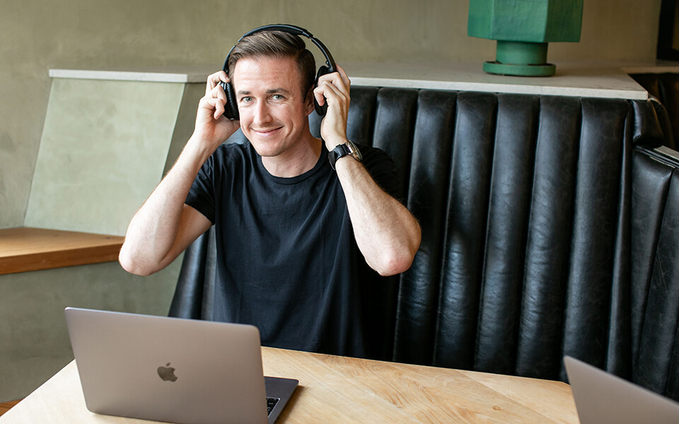 How to Start a Freelancing Business on the Side Ryan Robinson Freelance Working in a Coffee Shop Image